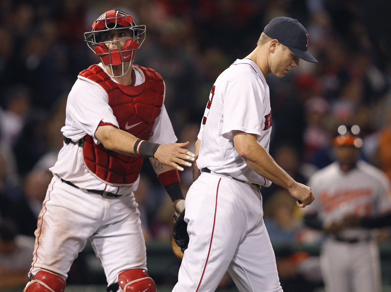 Catcher Jarrod Saltalamacchia pats closer Jonathan Papelbon on the back as Papelbon walks back to the mound after giving up a three-run double to Baltimore's Robert Andino in the eighth inning tonight at Fenway Park. Baltimore won, 7-5.