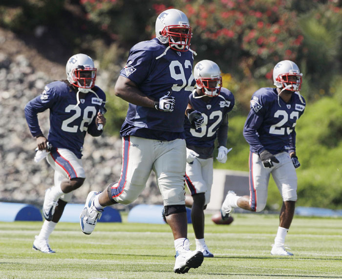 Patriots defensive tackle Albert Haynesworth (92) and teammates run drills during practice at the team's facility in Foxborough, Mass., on Wednesday.