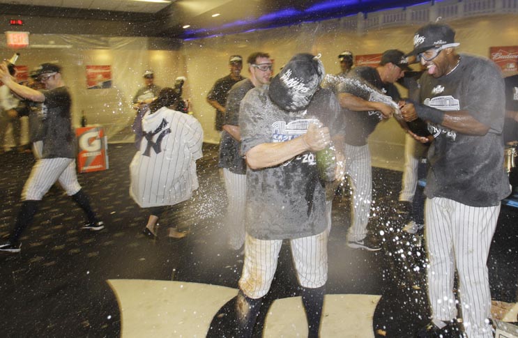 The Yankees celebrate after clinching the AL East title with a 4-2 win over the Tampa Bay Rays in the second game of a baseball doubleheader Wednesday.