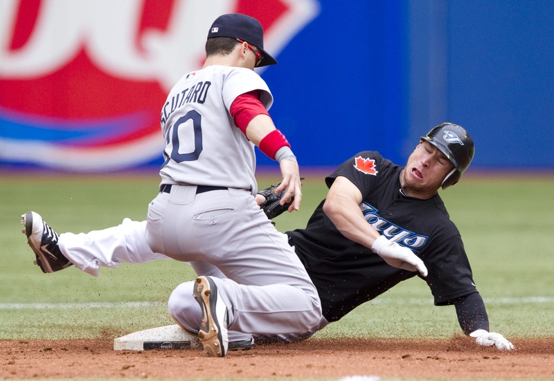 Toronto Blue Jays' Brett Lawrie, right, slides in to steal second under the tag of Boston Red Sox's Marco Scutaro during the second inning in Toronto on Monday. The Blue Jays defeated the Red Sox 1-0. color full length Toronto Toronto Blue Jays colour sports play physical field competitive competition compete athletics athletic athlete action BBA MLB single 2011