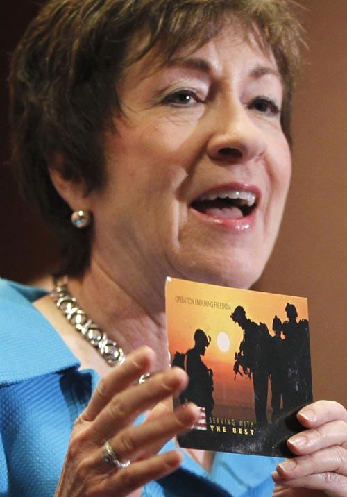 Sen. Susan Collins, R-Maine, holds up a postcard she received from an anonymous Army soldier in Afghanistan thanking her for her support of the repeal of "Don't Ask, Don't Tell."