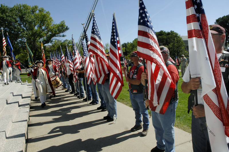 Members of The North Dakota Patriot Guard stand with flags as the Century High School Spirit of '76 marches in to present the colors during the Sept. 11 anniversary observance at the state Capitol building in Bismarck. Nationwide, the efforts of police and military forces allowed such ceremonies to take place without being blighted by terrorist reprisals.