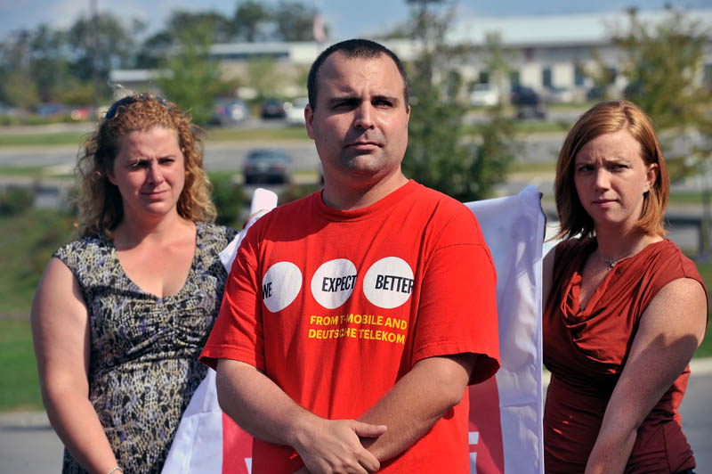 James McCoy, a current employee at T-Mobile, stands outside the Oakland call center Tuesday calling for the company to hire more employees or return taxpayer money. Behind him are Keri Evinson, with Communication Workers of America, and Tracy Allen, with the Maine AFL-CIO.