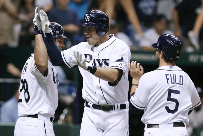 Evan Longoria, center, celebrates with teammates after his three-run homer. He later beat the Yankees with a walk-off homer.