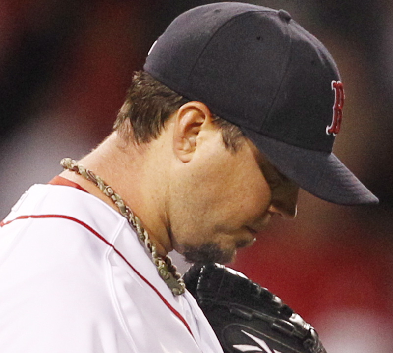 Josh Beckett reacts after giving up two hits to the Orioles in the eighth inning tonight at Fenway Park. Baltimore scored twice in the inning for a 6-4 win.