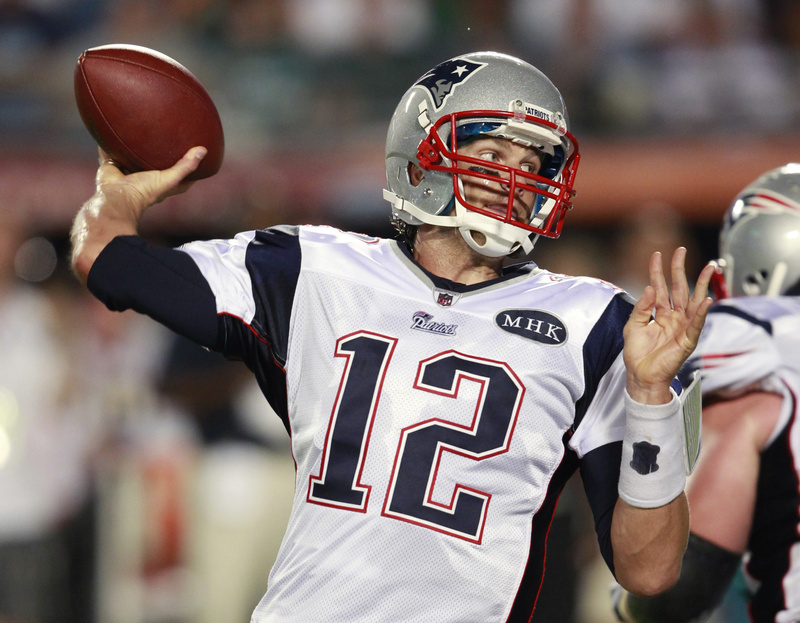 Patriots quarterback Tom Brady throws during the first half tonight's game in Miami. Brady threw for a team-record 517 yards and four TDs as the Patriots won 38-24.