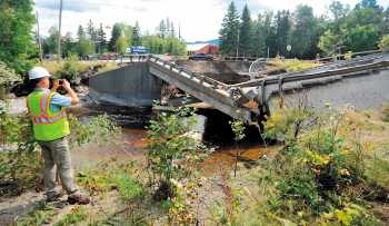 Ted Clark, a project manager for Reed & Reed General Contractors, surveys the damage to a bridge on Route 27 in Carrabassett Valley.