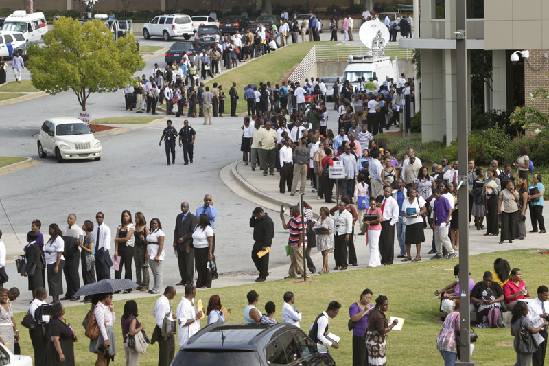 People wait in line during a job fair, sponsored by the Congressional Black Caucus, on the campus of Atlanta Technical College in Atlanta in August. Employers stopped adding jobs in August. CBC john lewis jobs employment unemployed job fair