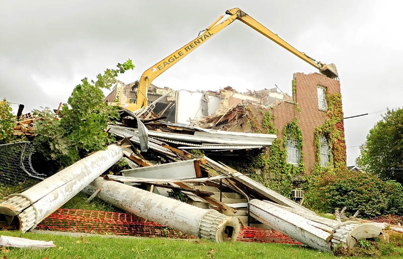 The columns sit on the ground as demolition continues today at the old Kennebec Valley YMCA building at the corner of State and Winthrop Streets in Augusta.