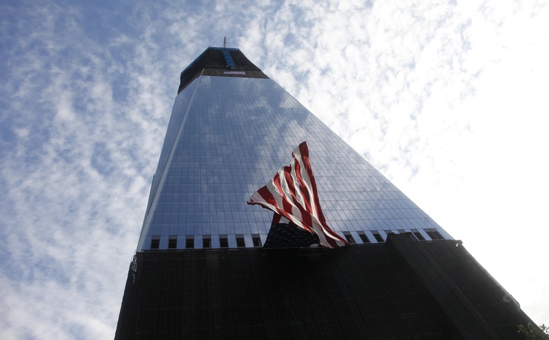 The U.S. flag hangs on Freedom Tower during the 10th Anniversary Commemoration Ceremony attended by President Barack Obama and former President George W. Bush, at Ground Zero today in New York.