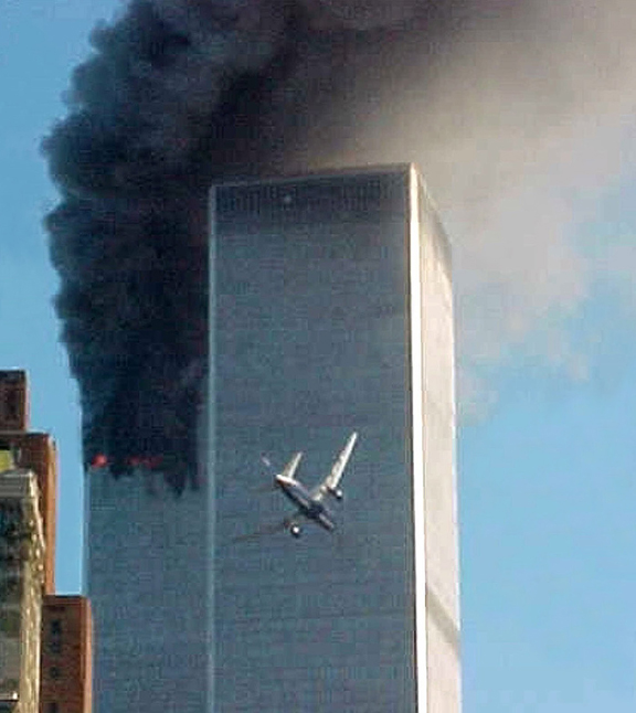 United Airlines Flight 175 approaches the south tower of the World Trade Center in New York shortly before collision as smoke billows from the north tower.