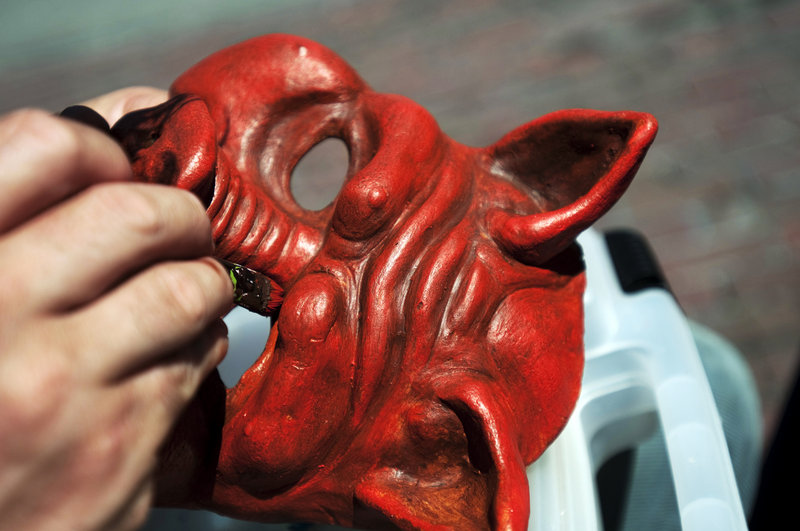 Leon Hastings of Portland paints one of his handcrafted neoprene masks during a recent Portland Farmers Market in Monument Square. Hastings and other Mainers who make crafts may soon be able to participate in a crafts-only open-air market in the square. A city lawyer is drawing up the first draft of a proposal.