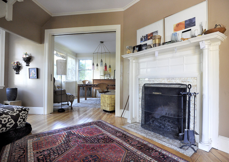 The living room, with its fireplace and elegant flow, is part of the original space designed by John Calvin Stevens.