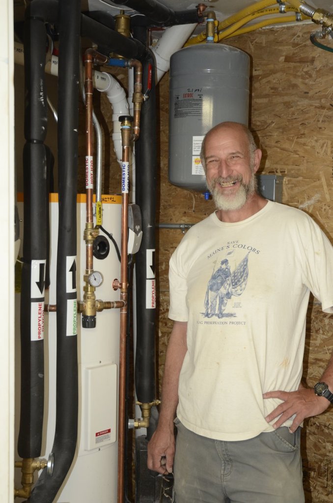 Paul Ledman proudly displays his house’s hot water system.