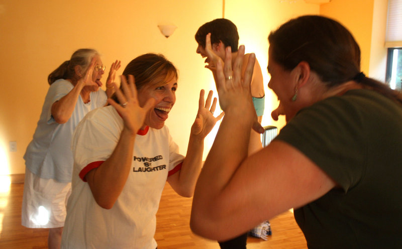 Laughter yoga instructor Katie West, founder of the Levity Project, goes one on one with a class member at a recent session at the Yogave studio on Route 1 in Falmouth.