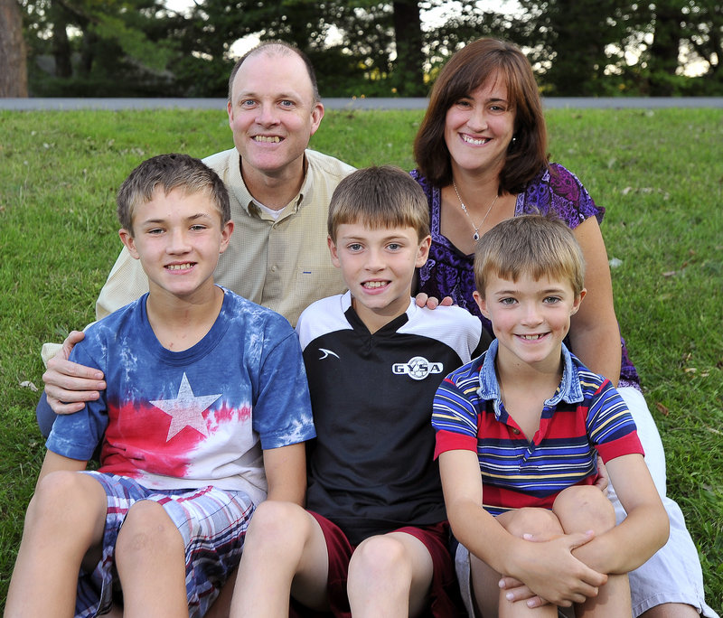 "The Mighty Five" Farrs gather for a family portrait on their lawn in Gorham at the end of last month: Ronnie and Jane Farr in back, with sons Aaron, 11, left; Ryan, who was born on Sept. 11, 2001, and turns 10 this year; and 7-year-old Andrew. His parents were unaware of the unfolding national tragedy as Ryan emerged just minutes before the World Trade Center's south tower collapsed.