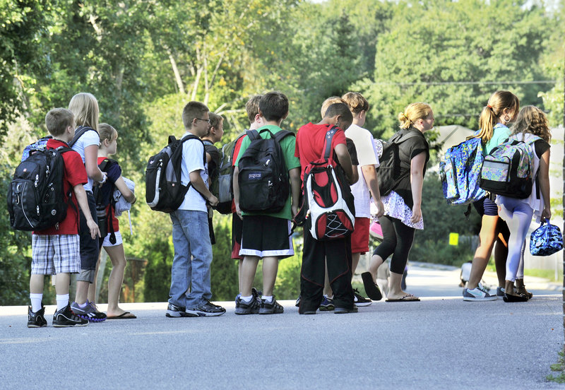 Students line up for the first day of school Wednesday at Dyer Elementary School in South Portland, while other schools open this week.