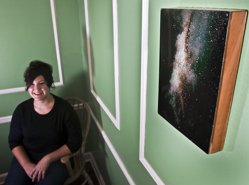 Erica Wren shows the first major piece of artwork she bought for her home in Leawood, Kan.