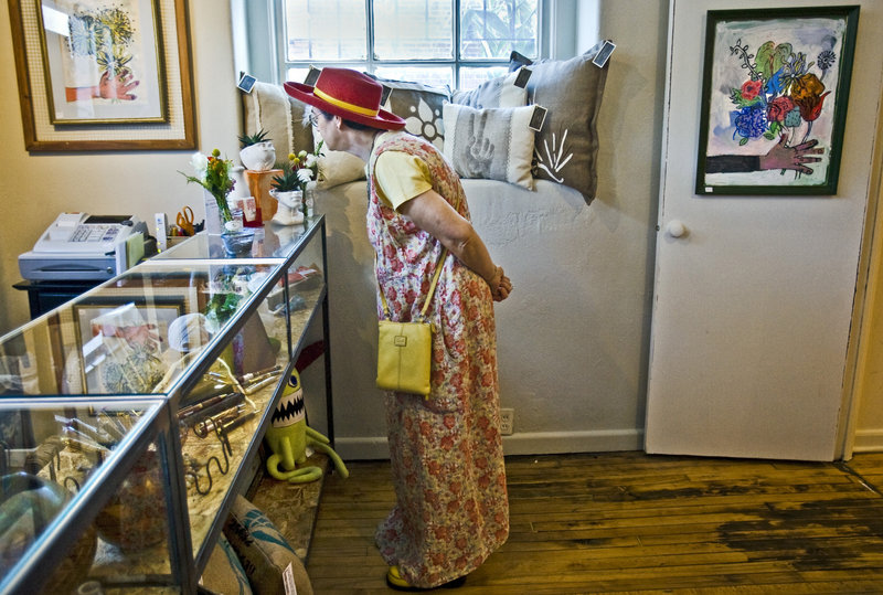 Susan Krotzinger looks at items in the gift shop at the Leedy-Voulkos Art Center In Kansas City, Mo.