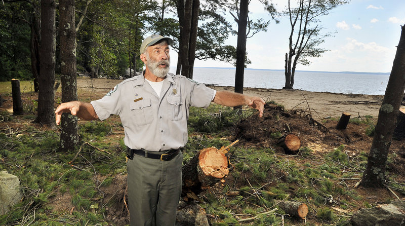 Park Manager Andy Haskell describes how high winds that reached 60 mph during Irene snapped, toppled and damaged many trees at the Witch Cove Beach area. Crews are working dawn to dusk to restore electricity and clean up the debris.