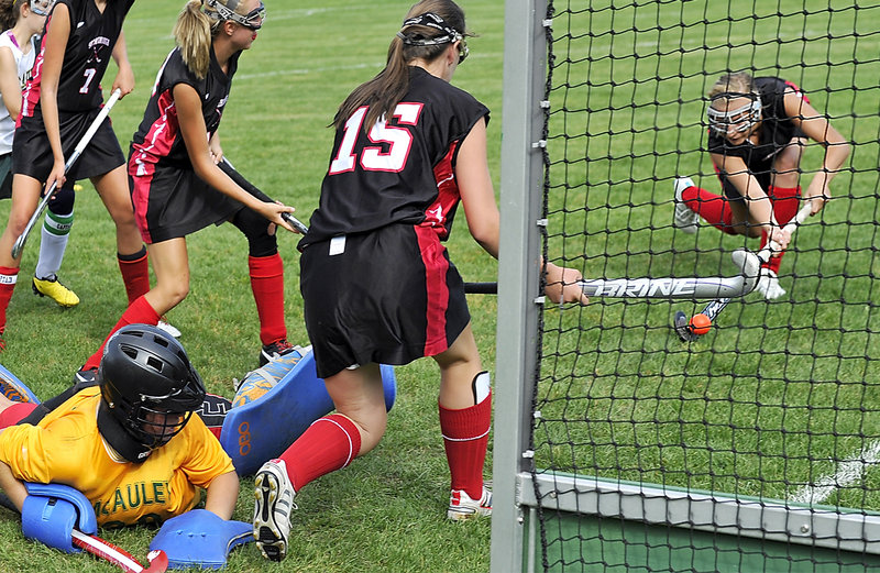 Emily Bunting of Scarborough finds an open net Wednesday as McAuley goalie Nicole Traugh is overrun by the Red Storm’s offense. Bunting scored three goals as Scarborough opened the field hockey season with a 7-0 victory on the road.