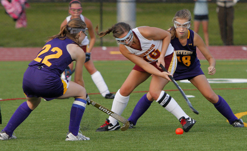 Mary Brown of Thornton Academy, center, looks for a way to control the ball around defense applied by Sarah LaQuerre, left, and Staci Swallow of Cheverus during Cheverus' 5-0 victory.