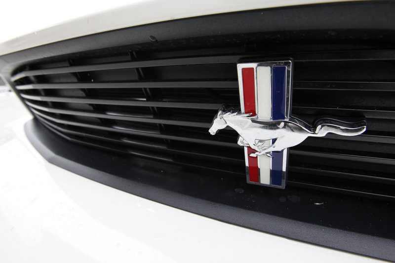 The Mustang medallion shines on the grille of a new Ford model at a dealership in Miami. Ford was one of several automakers that reported double-digit sales increases on Thursday.