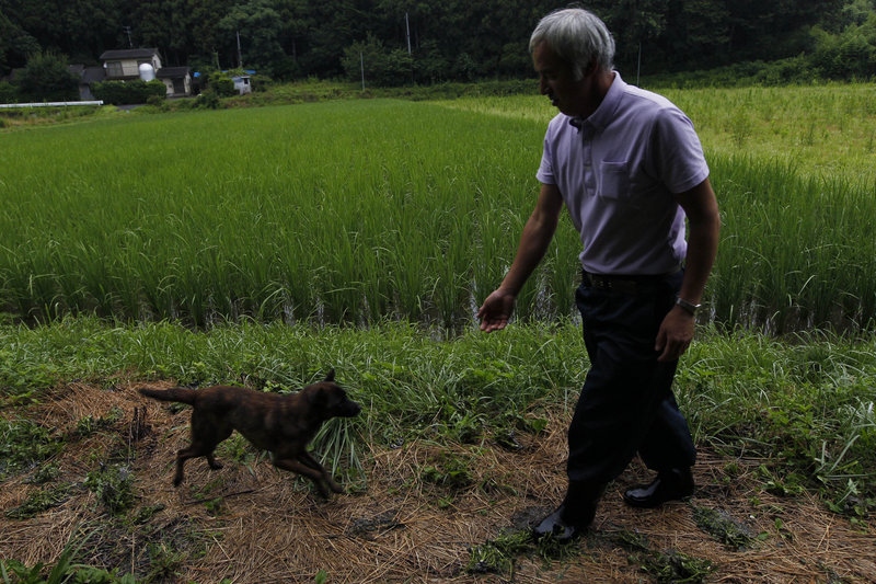 Naoto Matsumura tends to local pets, including this dog, Aki, which were left behind after the Japanese government on March 11 ordered the 16,000 residents of Tomioka to evacuate after the Fukushima Dai-ichi nuclear power plant crisis. Said Matsumura, 53: “If I give up and leave, it’s all over.”