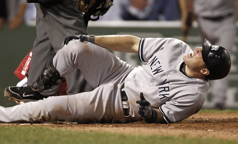 Mark Teixeira of the New York Yankees grabs his knee Thursday night after being plunked by an Alfredo Aceves pitch in the sixth inning. New York beat the Red Sox, 4-2.