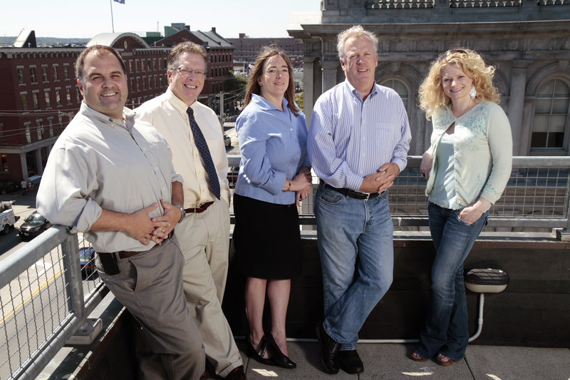 From left, MaineToday Digital executives Brent Taylor, manager of digital operations; Barry Jackman, director of advertising sales and marketing; Angie Muhs, executive editor; Steve Galligan, president; and Jaica Kinsman, executive producer, stand on the balcony of the company’s offices at 7 Custom House St. in Portland on Friday.