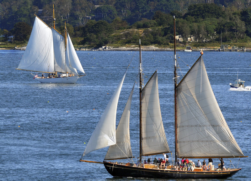 The Wendameen, top, and the Bagheera, both owned by the Portland Schooner Co., are seen under sail in Casco Bay recently. The boats have each run aground in the last two years, prompting discussion of safety and regulations by the Portland Harbor Commission.