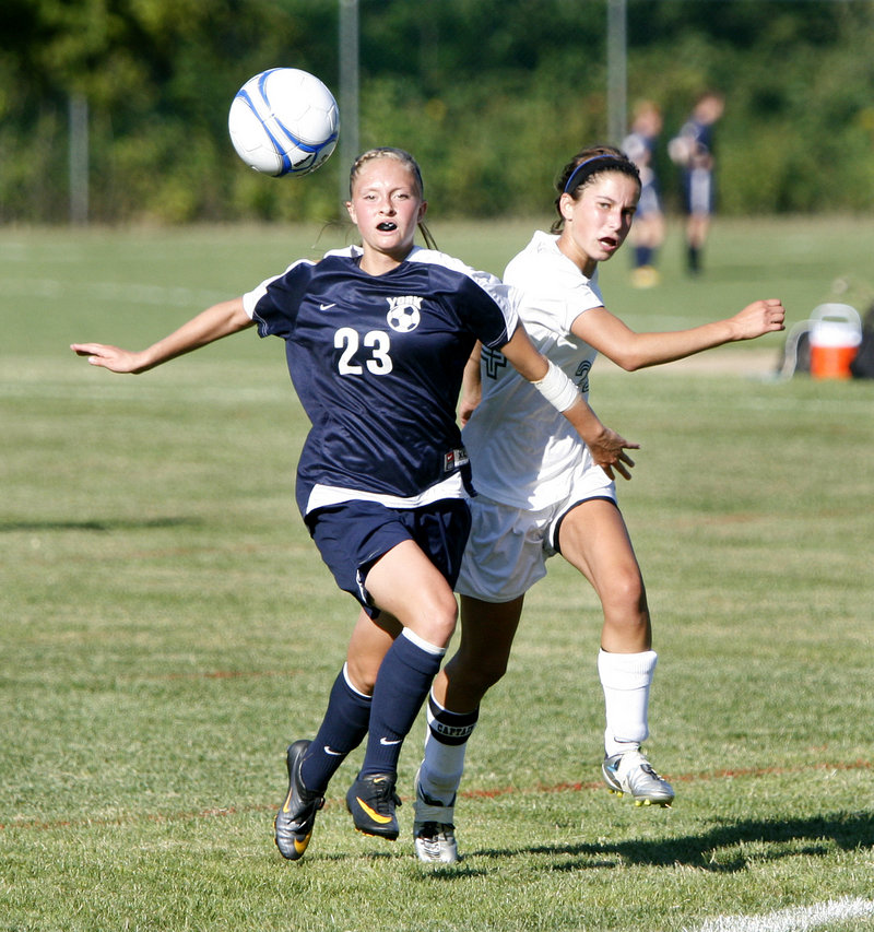 Kayla Swasey, left, of York tries to keep Waynflete's Katherine Harwood from the ball while on the run Friday in a girls' soccer game at Portland. Swasey had a goal and an assist in the Wildcats' season-opening 8-0 victory.
