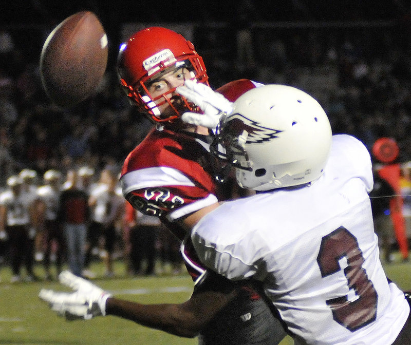 Tony Green-Taylor of Windham, right, breaks up a pass intended for Conor McCann of Scarborough in the second quarter of Scarborough s 21-6 victory Friday night.