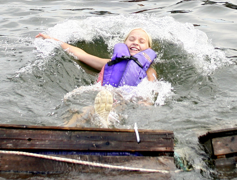 Abby Doherty, 10, of Kennebunk keeps smiling after taking a plunge during the lobster crate race.
