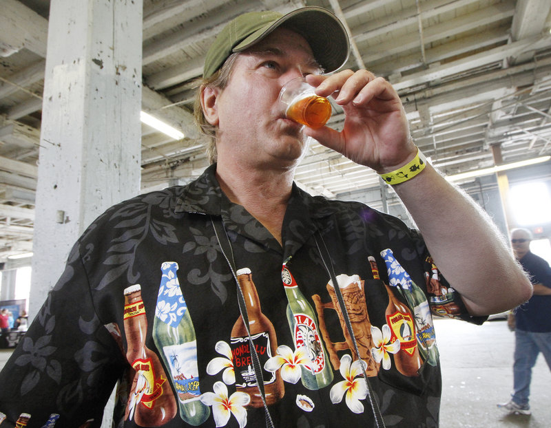 Marco Graves of Portland, wearing an appropriate shirt, tastes a sample of Octoberfest made by Samuel Adams at the annual Portland Brew Festival on Saturday.