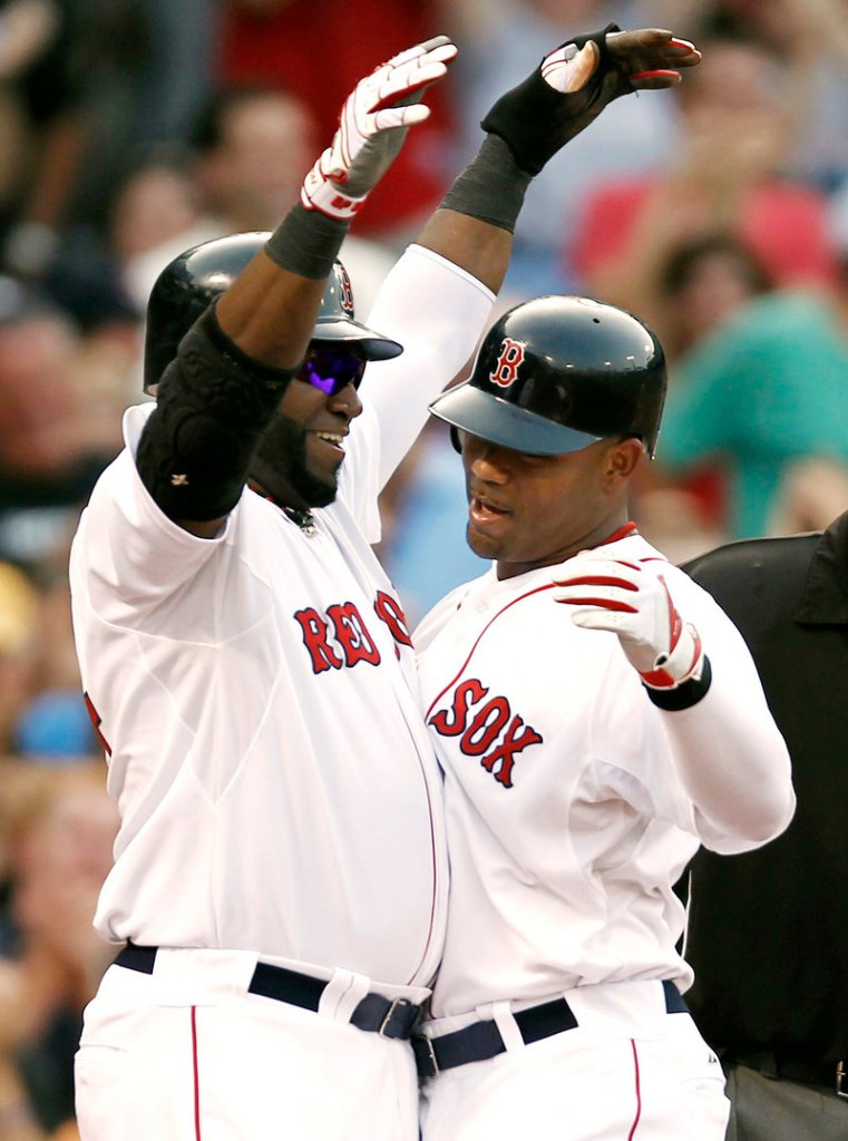 David Ortiz, left, greets Carl Crawford after Crawford’s grand slam that helped the Red Sox beat the Rangers.