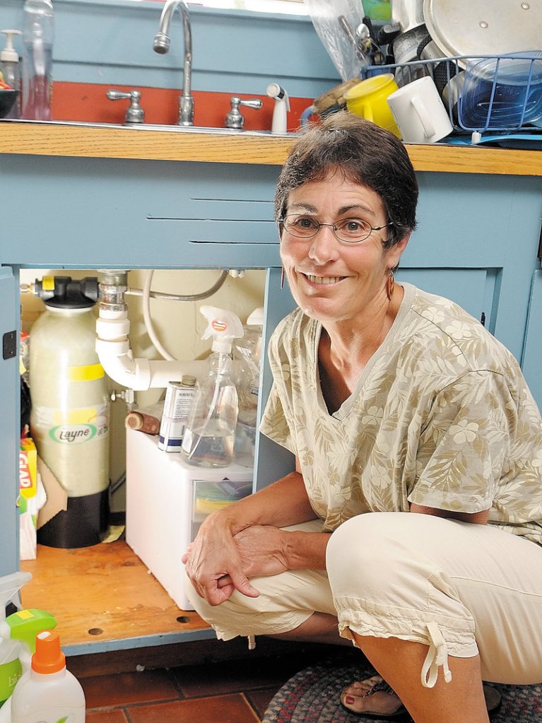 Beth Nagusky uses an under-the-sink filtration system to remove arsenic from the well water at her home in Litchfield.