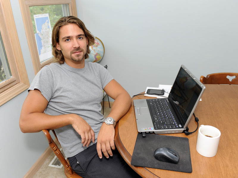 Ryan McGrath, 26, sits in his home in Michigan City, Ind. McGrath has been working part time designing websites for small businesses but wants steadier full-time work.