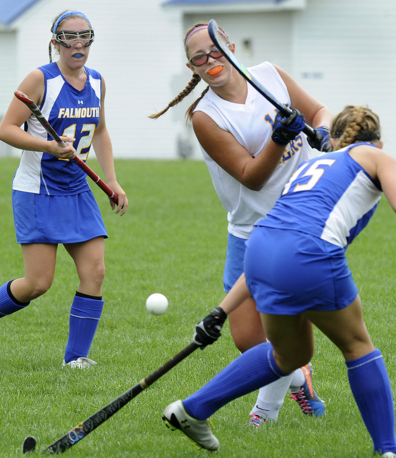 Working between Falmouth's Megan Fortier, left, and Hayley Winslow, right, Lake Region's Kayleigh Lepage gets off a shot Monday against the Yachtsmen.