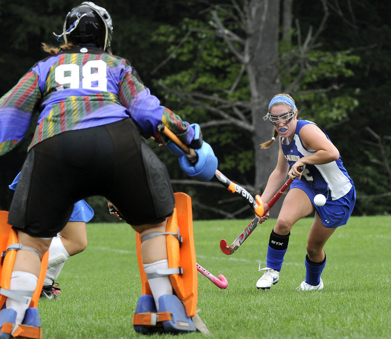 Lake Region goalie Shannon VanLoan moves into position as Falmouth midfielder Megan Fortier looks to control a bouncing ball Monday afternoon during their Western Maine Conference field hockey game in Naples. The teams ended the game tied, 1-1.