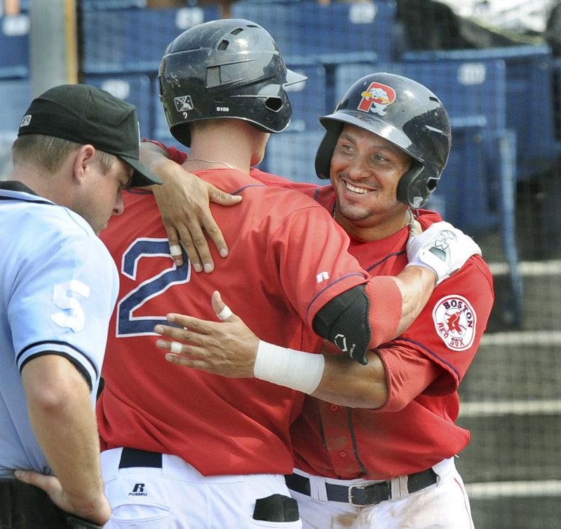 Jeremy Hazelbaker, left, and Ryan Dent celebrate after Hazelbaker's two-run homer Monday in Portland's final game of the 2011 season, at Hadlock Field.