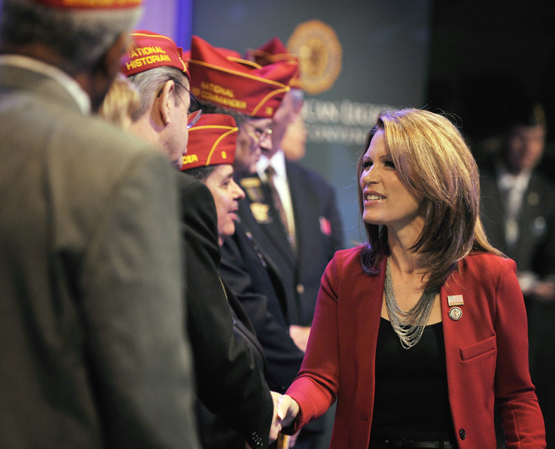 Republican presidential candidate Rep. Michele Bachmann, R-Minn., greets American Legion officers after addressing the national convention last Thursday in Minneapolis. Bachmann opened a tea party-backed forum Monday in South Carolina.