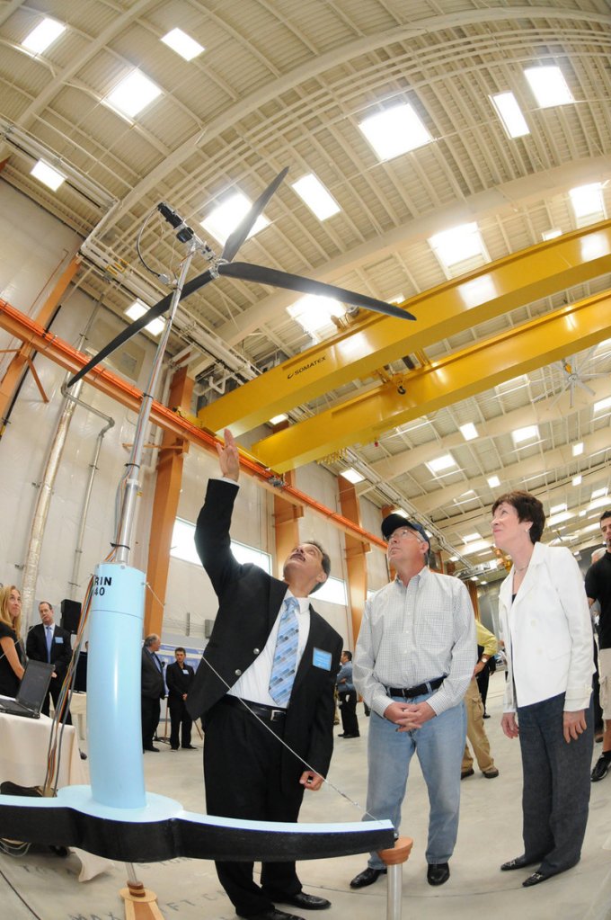 Habib Dagher, director of the University of Maine’s Advanced Structures and Composites Center, left, shows U.S. Interior Secretary Ken Salazar and Sen. Susan Collins a scale model of a floating wind turbine in Orono. A $3 million federal grant will be used for a component lab that will build prototype blades, towers and hulls for floating windmills.