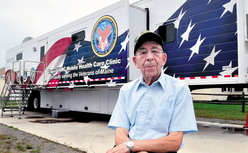 Veteran Joe Bourque, who is 92, stands outside the mobile health clinic near his home in Bingham on Sunday. Bourque and others will learn more this Wednesday at a public meeting about why the clinic will close.