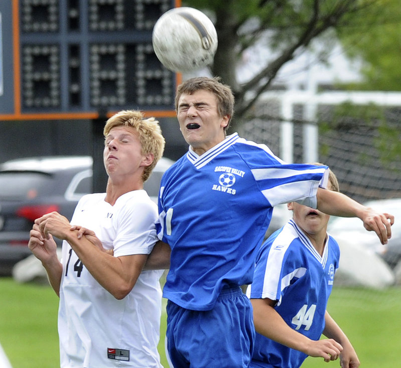 Trey Watson of Sacopee Valley gets his head on the ball Tuesday while holding off Jacob Scammon of North Yarmouth Academy. Watson scored a goal during Sacopee s 2-0 victory at Yarmouth.