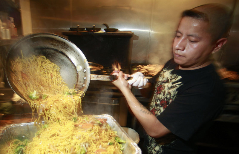 Israel Hernandez prepares food at the Bamboo Grove Hawaiian Grille in Portland, Ore. Service firms grew at slightly faster pace in August compared with July, but the sector remains weak.