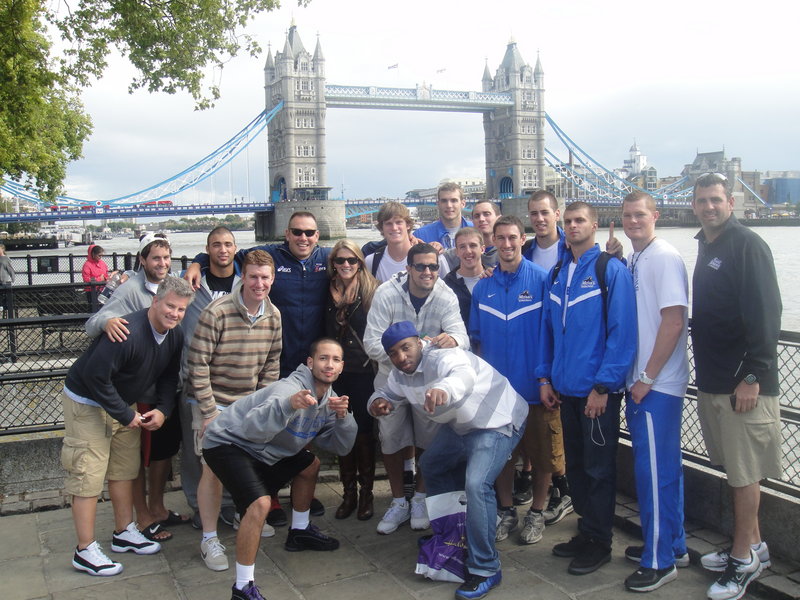 With Tower Bridge as a backdrop, players, coaches and alumni of the St. Joseph s basketball team pose for a photo during their recent offseason trip to England, where they soaked up the culture, bonded and played some basketball, too.