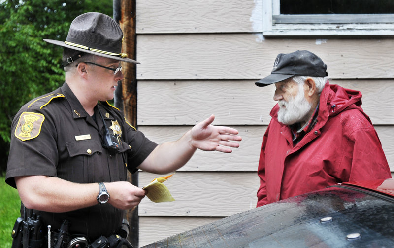 Deputy Matthew Thompson gives a temporary inspection permit to a Gray resident. Thompson will “use enforcement when necessary and do some problem-solving with people who have quality-of-life issues,” said Sheriff Kevin Joyce.