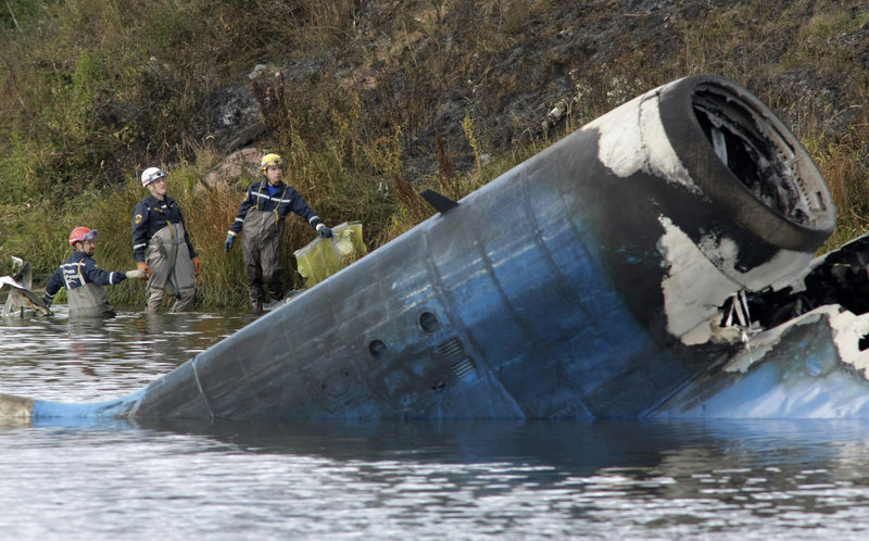 Rescuers on Wednesday survey the wreckage of a Russian Yak-42 jet that was carrying a Russian professional hockey team and crashed after takeoff some 150 miles from Moscow.
