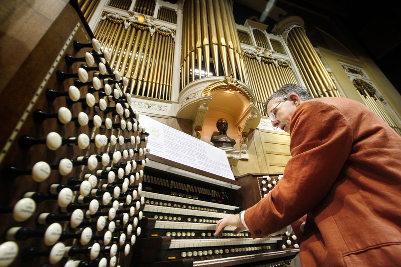 Ray Cornils, the municipal organist for Portland, plays the Kotzchmar Organ Thursday at Merrill Auditorium. The city and Friends of the Kotzschmar Organ will share the $2.5 million cost of renovating the 100-year-old organ.